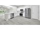 Open-concept kitchen with white cabinets, stainless steel appliances, and view to dining area at 4910 Chatham Gate Dr, Riverview, FL 33578