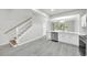 Bright and modern kitchen with stainless steel appliances and stairs leading to upper level at 4910 Chatham Gate Dr, Riverview, FL 33578