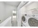 Well-lit laundry area features modern appliances, convenient shelving, and views into the adjacent room at 4910 Chatham Gate Dr # Dr, Riverview, FL 33578
