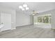 Open living area boasts sliding glass doors to the patio and wood-look flooring at 4910 Chatham Gate Dr, Riverview, FL 33578