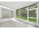 Screened patio with a view of the fenced backyard with mature trees and lush green lawn at 4910 Chatham Gate Dr, Riverview, FL 33578