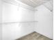 Walk-in closet features modern gray flooring and plenty of storage space with metal shelving at 4910 Chatham Gate Dr, Riverview, FL 33578