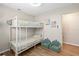 A bedroom with bunkbeds, natural light, and cozy shell chairs at 512 Flame Tree Dr, Apollo Beach, FL 33572