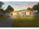 Charming single-story home featuring well-maintained landscaping, a long driveway, and cozy front porch at 512 Flame Tree Dr, Apollo Beach, FL 33572