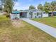Charming single-story home featuring well-maintained landscaping, a long driveway, and cozy front porch at 512 Flame Tree Dr, Apollo Beach, FL 33572
