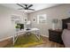 This home office features bright natural light, a modern white desk and wood flooring at 512 Flame Tree Dr, Apollo Beach, FL 33572