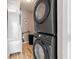 Modern laundry room with stacked washer and dryer, and stylish decor at 512 Flame Tree Dr, Apollo Beach, FL 33572