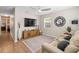 Comfortable living room with a modern ceiling fan, a large TV, and a cozy seating area at 512 Flame Tree Dr, Apollo Beach, FL 33572