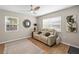 Comfortable living room with a modern ceiling fan, a large window, and a cozy seating area at 512 Flame Tree Dr, Apollo Beach, FL 33572