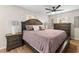A relaxing main bedroom with a ceiling fan, wood floors, and a warm color palette at 512 Flame Tree Dr, Apollo Beach, FL 33572