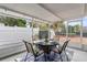 Enclosed patio with outdoor dining set and view of the fenced backyard at 512 Flame Tree Dr, Apollo Beach, FL 33572