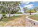 Large backyard featuring mature trees, a white fence, a small shed, and green space at 5540 Applegate Dr, Spring Hill, FL 34606