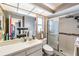 Well-lit bathroom with a glass shower, sink with white cabinets, and neutral wall colors at 5540 Applegate Dr, Spring Hill, FL 34606