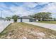 Stylish home with a well-maintained lawn, a long driveway, and a two-car garage at 5540 Applegate Dr, Spring Hill, FL 34606