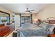 Comfortable main bedroom featuring a ceiling fan, sliding glass doors, and ensuite bathroom at 5540 Applegate Dr, Spring Hill, FL 34606