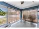 Enclosed patio with blue walls, neutral floors, and shade coverings for relaxation and privacy at 5540 Applegate Dr, Spring Hill, FL 34606
