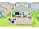 Aerial view of a private backyard with a brick patio, fire pit, and outdoor kitchen at 6118 Voyagers Pl, Apollo Beach, FL 33572