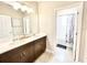 Cozy bathroom features a double sink, white quartz countertops, and a shower and tub combo at 6118 Voyagers Pl, Apollo Beach, FL 33572
