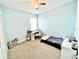 Well-lit bedroom with a desk, guitar, and light blue painted walls at 6118 Voyagers Pl, Apollo Beach, FL 33572
