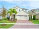 Well-maintained two-story house with a brick driveway, two car garage and landscaping at 6118 Voyagers Pl, Apollo Beach, FL 33572