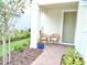 Inviting front porch with a cozy seating area, lush landscaping, and a charming entrance at 6118 Voyagers Pl, Apollo Beach, FL 33572