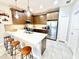 Open-concept kitchen featuring a large island, stainless steel appliances, and a breakfast bar at 6118 Voyagers Pl, Apollo Beach, FL 33572