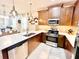 Modern kitchen with stainless steel appliances, quartz countertops, and ample cabinet space at 6118 Voyagers Pl, Apollo Beach, FL 33572