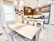 Stylish eat-in kitchen features modern appliances, pendant lighting, and a spacious dining area at 6118 Voyagers Pl, Apollo Beach, FL 33572