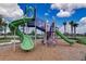 Community playground with green slides and climbing structure set against a bright sky at 6118 Voyagers Pl, Apollo Beach, FL 33572