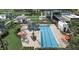 Aerial shot of a community pool with lap lanes, lounge chairs, and shaded seating areas at 6118 Voyagers Pl, Apollo Beach, FL 33572