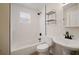 Clean bathroom with tiled shower-tub combination, modern fixtures, and a neutral color palette at 6419 S Englewood Ave, Tampa, FL 33611