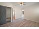 Bright bedroom featuring wood-look flooring, barn door closet, and ensuite access at 6419 S Englewood Ave, Tampa, FL 33611