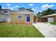 Charming bungalow with a blue front door, fresh landscaping, and off street parking at 6419 S Englewood Ave, Tampa, FL 33611