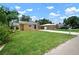 Charming single-story home with a well-manicured lawn, complemented by vibrant landscaping and a welcoming blue front door at 6419 S Englewood Ave, Tampa, FL 33611