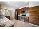 Well-equipped kitchen with stainless steel appliances, granite countertops, and dark wood cabinets at 6419 S Englewood Ave, Tampa, FL 33611