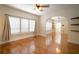 Spacious living room featuring polished hardwood floors, large windows, and arched doorway at 6419 S Englewood Ave, Tampa, FL 33611