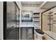 Chic bathroom with black vanity, modern fixtures, glass enclosed shower and animal print accent at 644 Yardarm Dr # 22, Apollo Beach, FL 33572