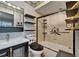 Contemporary bathroom featuring a sleek vanity, storage shelves, and a shower with glass doors at 644 Yardarm Dr # 22, Apollo Beach, FL 33572
