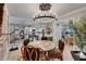 Stylish dining room with unique chandelier, designer table, and views of the kitchen and laundry room at 644 Yardarm Dr # 22, Apollo Beach, FL 33572