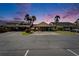 Charming exterior of the home featuring a covered parking area and lush landscaping at dusk at 644 Yardarm Dr # 22, Apollo Beach, FL 33572