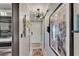 Inviting hallway featuring decorative artwork, a modern light fixture, and a tile floor at 644 Yardarm Dr # 22, Apollo Beach, FL 33572