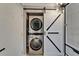 Efficient laundry closet with a stackable washer and dryer, complemented by a sliding barn door at 644 Yardarm Dr # 22, Apollo Beach, FL 33572