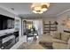 Spacious living room with a sectional sofa, access to a patio, and contemporary decor at 644 Yardarm Dr # 22, Apollo Beach, FL 33572