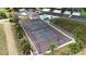 Aerial view of well-maintained community tennis court, adjacent to pool, parking area, and condos at 644 Yardarm Dr # 22, Apollo Beach, FL 33572