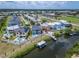 Stunning aerial view of the home showcasing the waterfront access with boat lift and in-ground pool at 6520 Simone Shores Cir, Apollo Beach, FL 33572