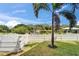 View of a white picket fence and dock in the backyard at 6520 Simone Shores Cir, Apollo Beach, FL 33572