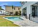 Backyard with a swimming pool, lush lawn, and modern design at 6520 Simone Shores Cir, Apollo Beach, FL 33572