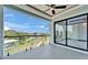 Spacious balcony with glass railings overlooking a waterfront view and sliding glass doors at 6520 Simone Shores Cir, Apollo Beach, FL 33572