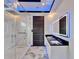 Modern bathroom features a glass enclosed shower, double sink vanity with an illuminated mirror, and LED lighting at 6520 Simone Shores Cir, Apollo Beach, FL 33572