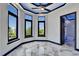Bright bedroom boasts large windows, marble floors, and ambient lighting, creating a modern and inviting space at 6520 Simone Shores Cir, Apollo Beach, FL 33572
